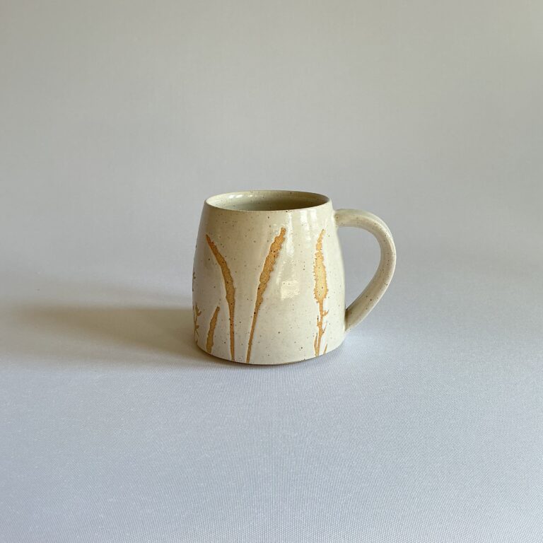 White stoneware cup with hedgerow design