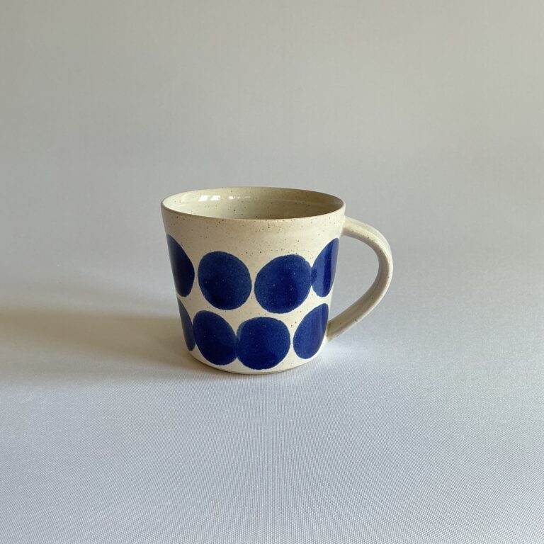 Stoneware cup with large indigo spot design