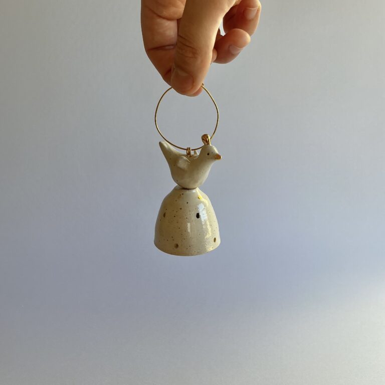 Christmas tree bell, stoneware with gold spot design and topped with a bird.