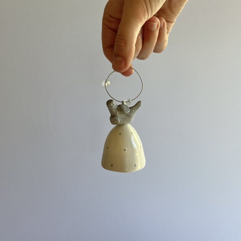 Christmas tree bell, porcelain with circular pencil design and topped with a handmade Grey seal.