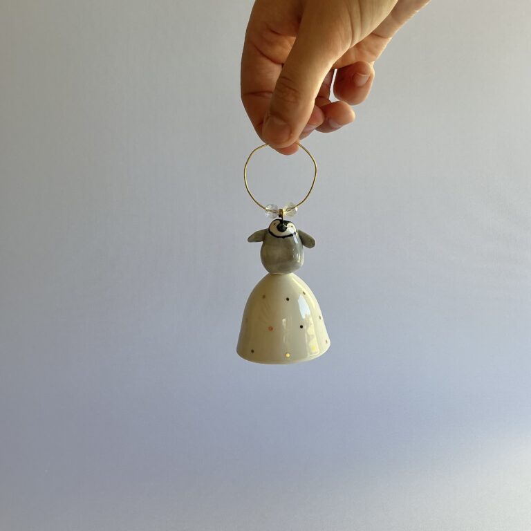 Christmas tree bell, porcelain topped with a baby penguin