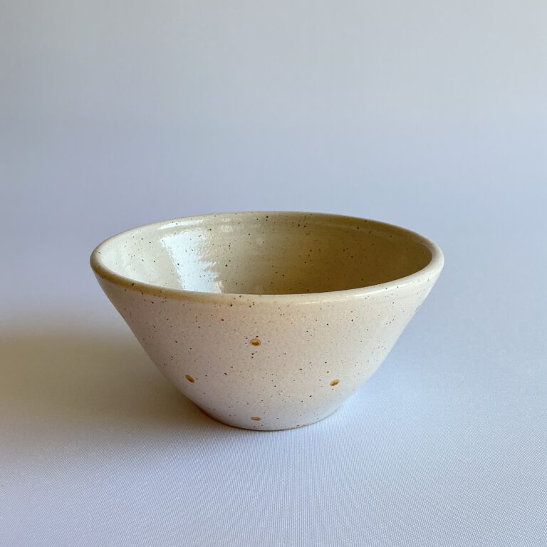 Stoneware bowl with gold spot design